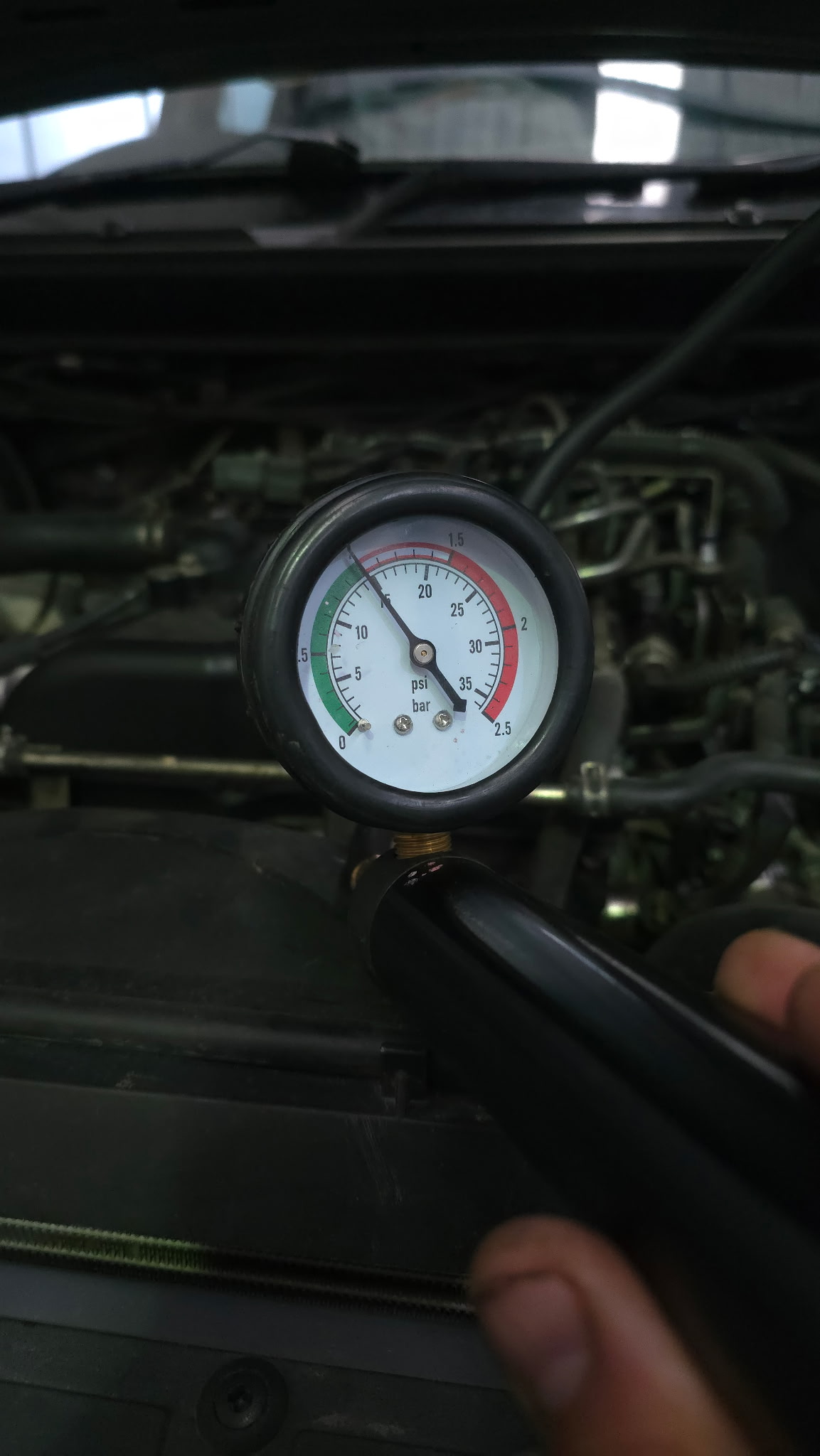 Fuel pressure gauge reading on an engine bay — diagnostics at Auto Labs