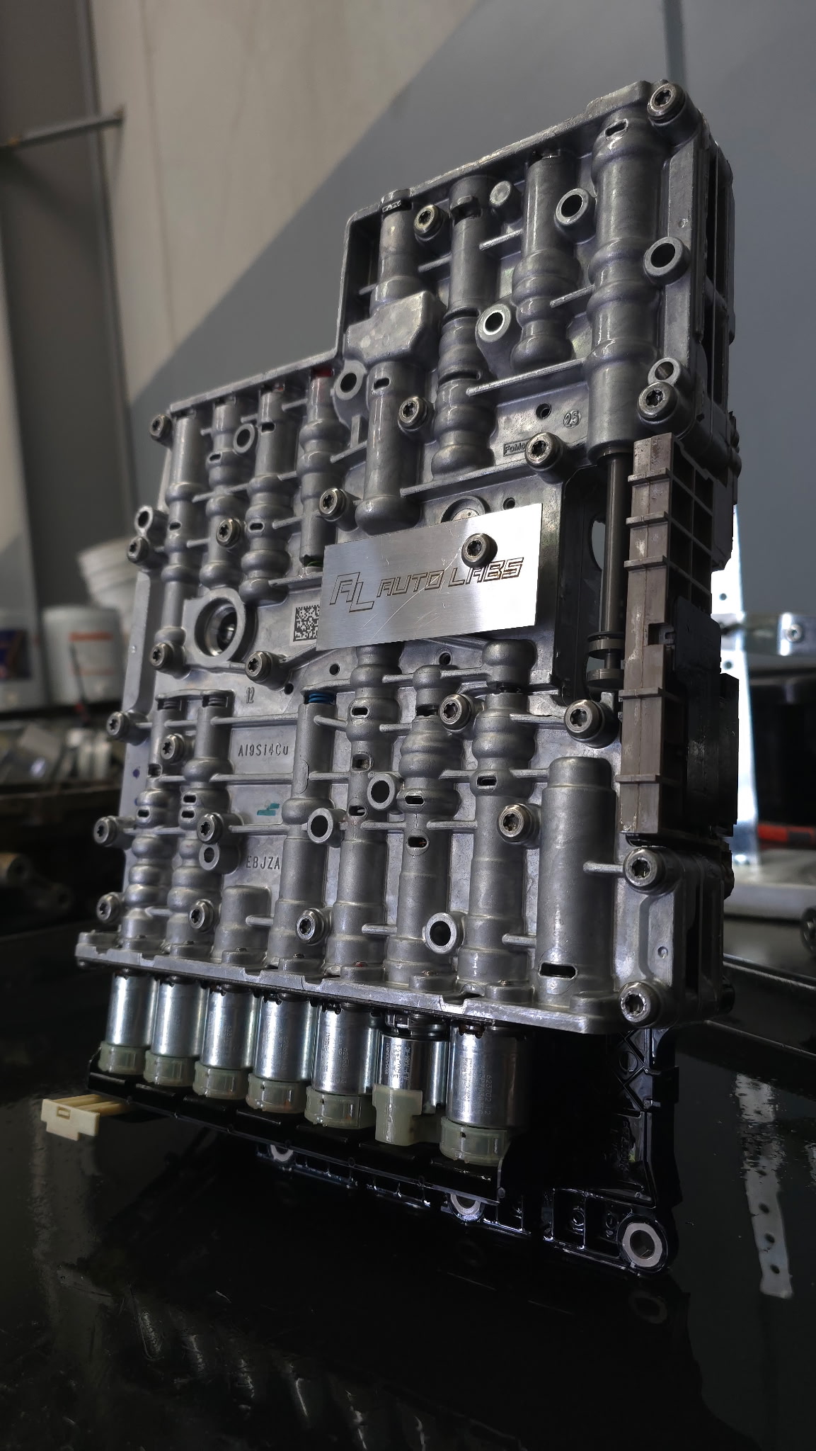 Rebuilt transmission valve body with Auto Labs identification badge