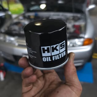 HKS oil filter genuine premium part held in hand at Auto Labs workshop Pakenham
