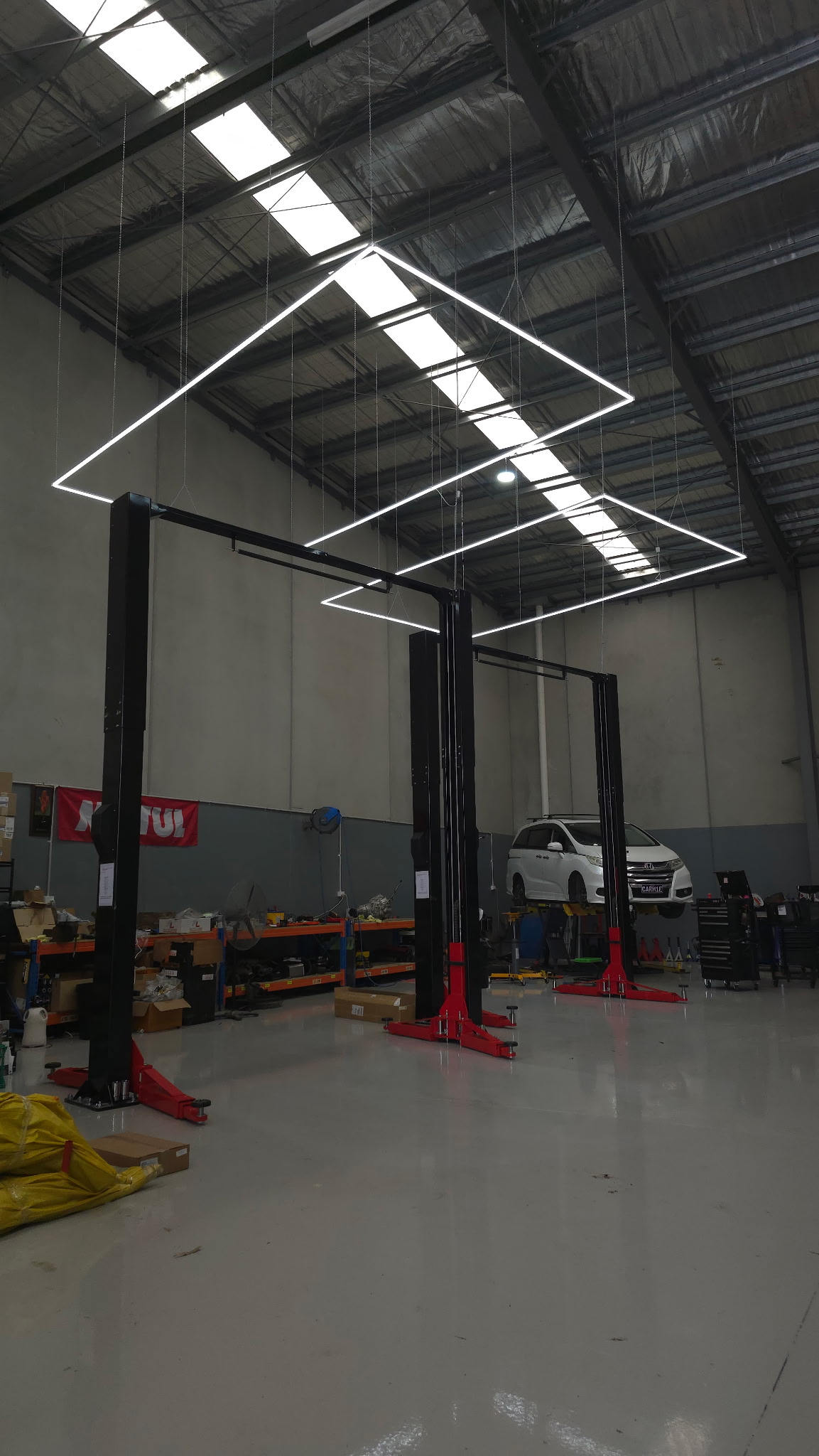 Inside Auto Labs Performance Centre — twin two-post hoists, overhead LED rig, the one-man workshop at Factory 18 Pakenham